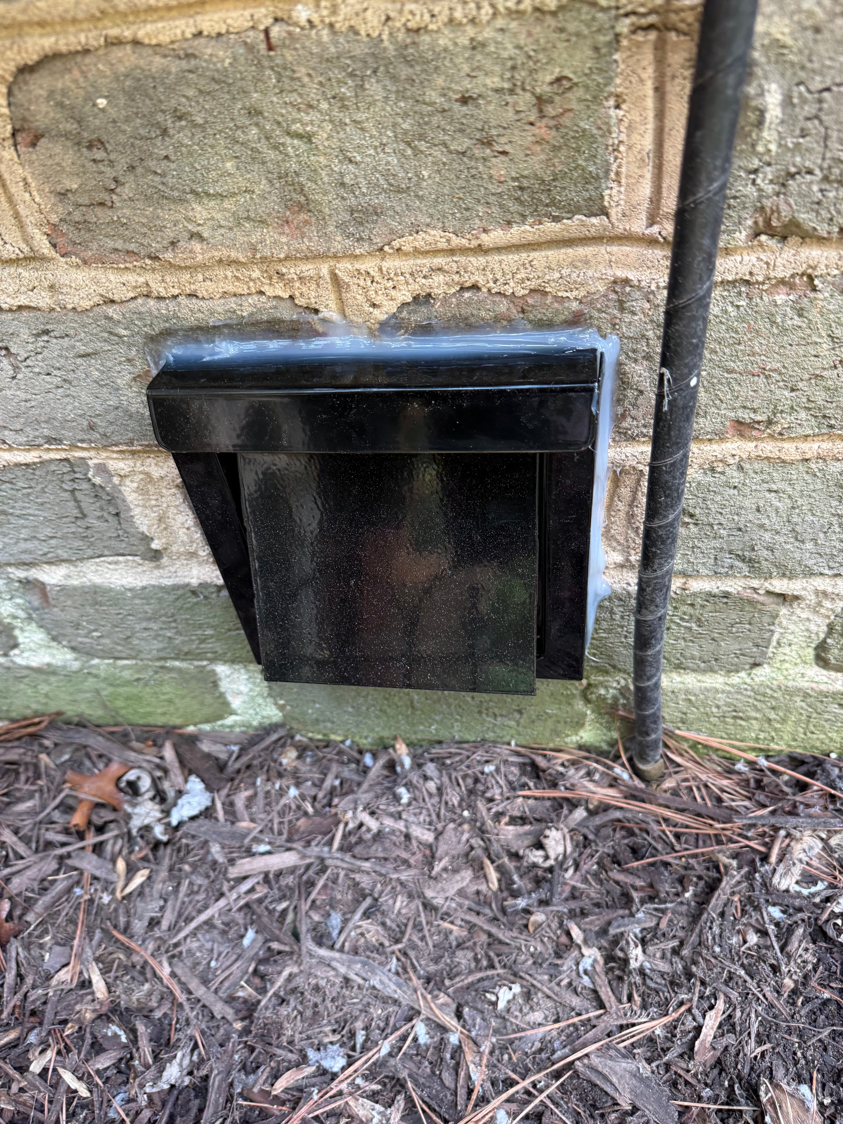New dryer vent cap on brick wall — Apex, NC